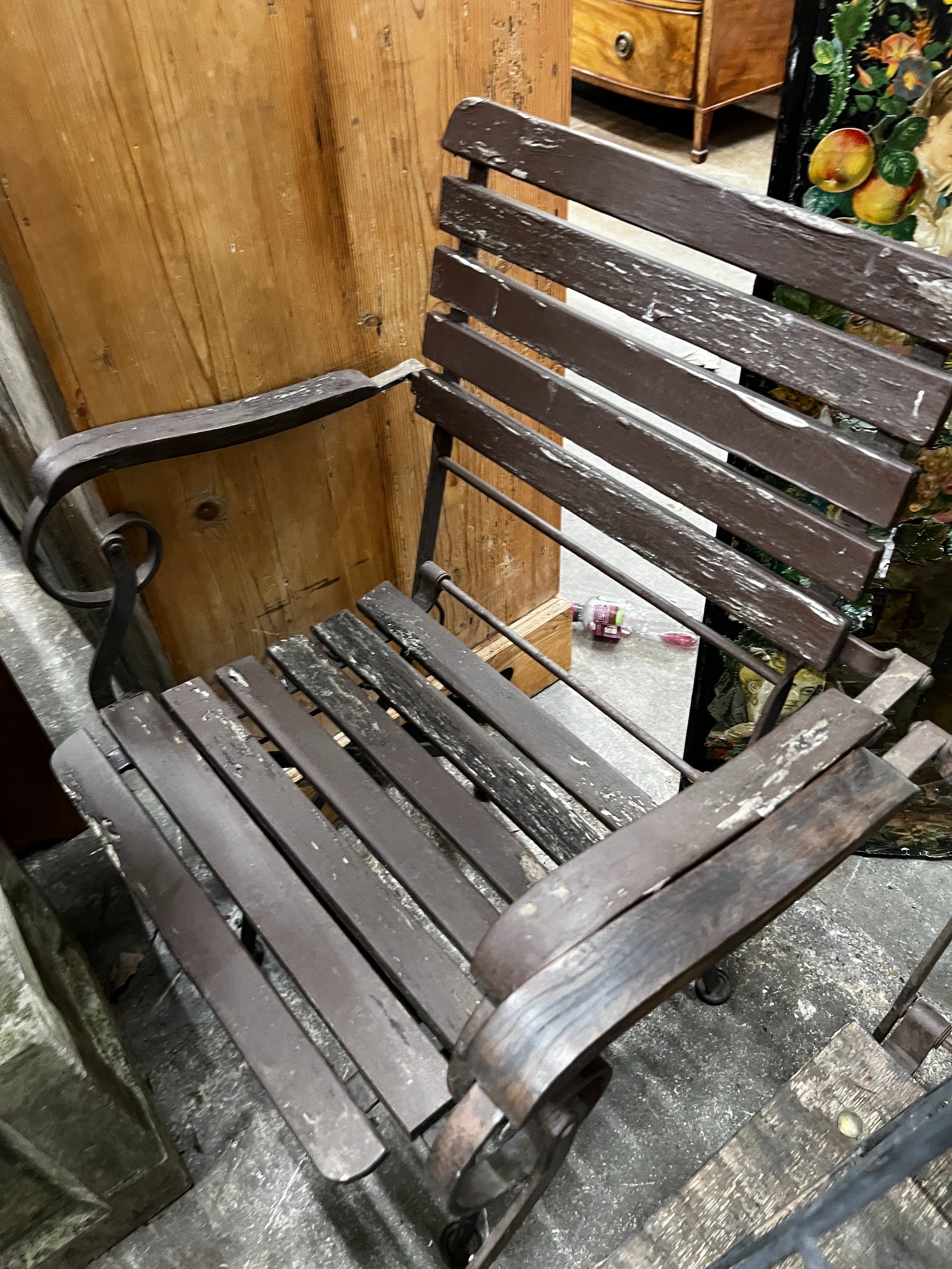 A wrought iron garden growing frame, height 130cm together with three wrought iron folding garden chairs